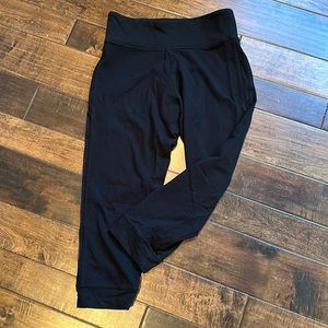 Victoria Sport black medium leggings with mesh insert on outside of legs.